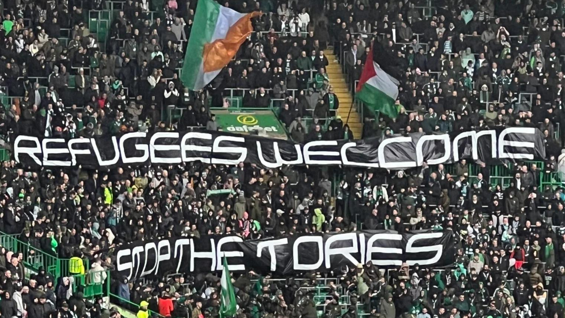 Celtic FC fans holding a banner